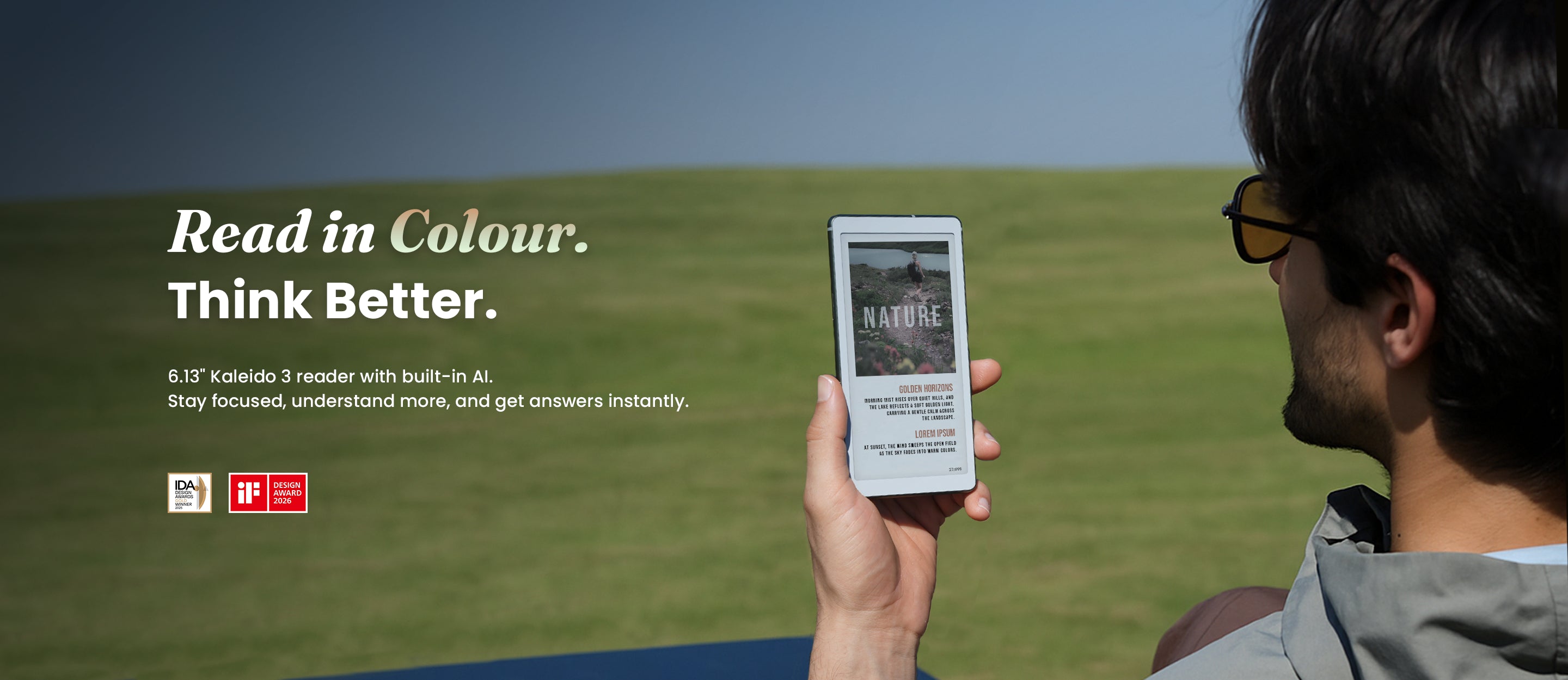 Person holding a viwoods aipaper digital device with 'Read in Colour. Think Better.' text on a grassy field.