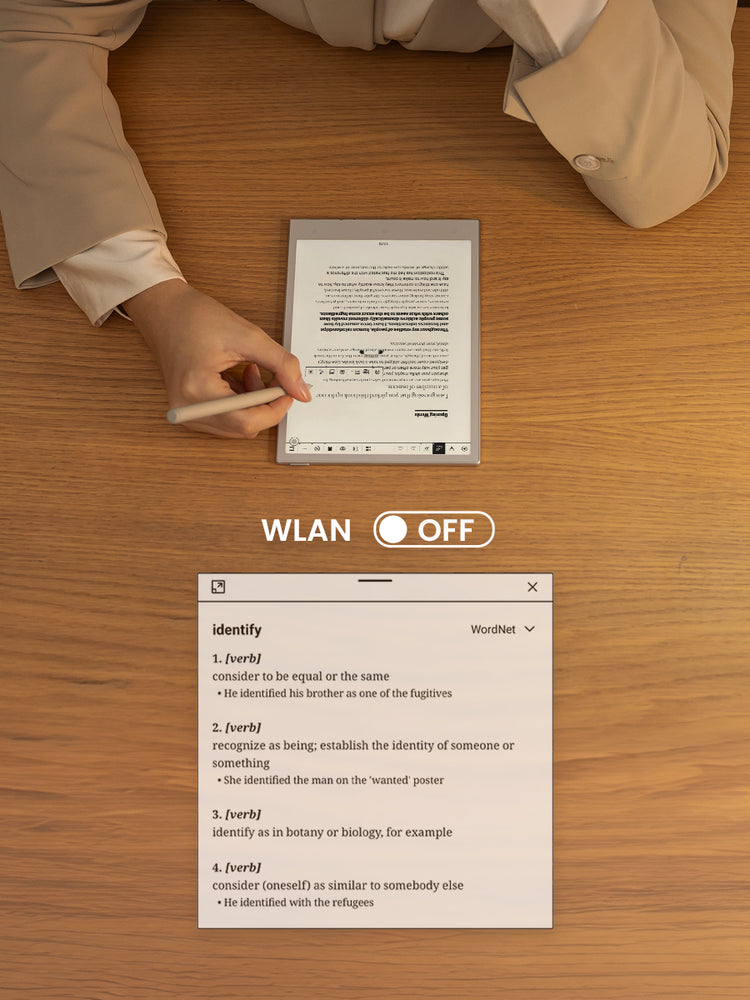Person using a digital paper tablet on a wooden surface with 'WLAN OFF' message displayed.