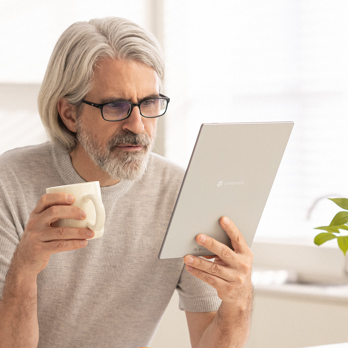 Person reading on Viwoods AiPaper in a bright indoor setting