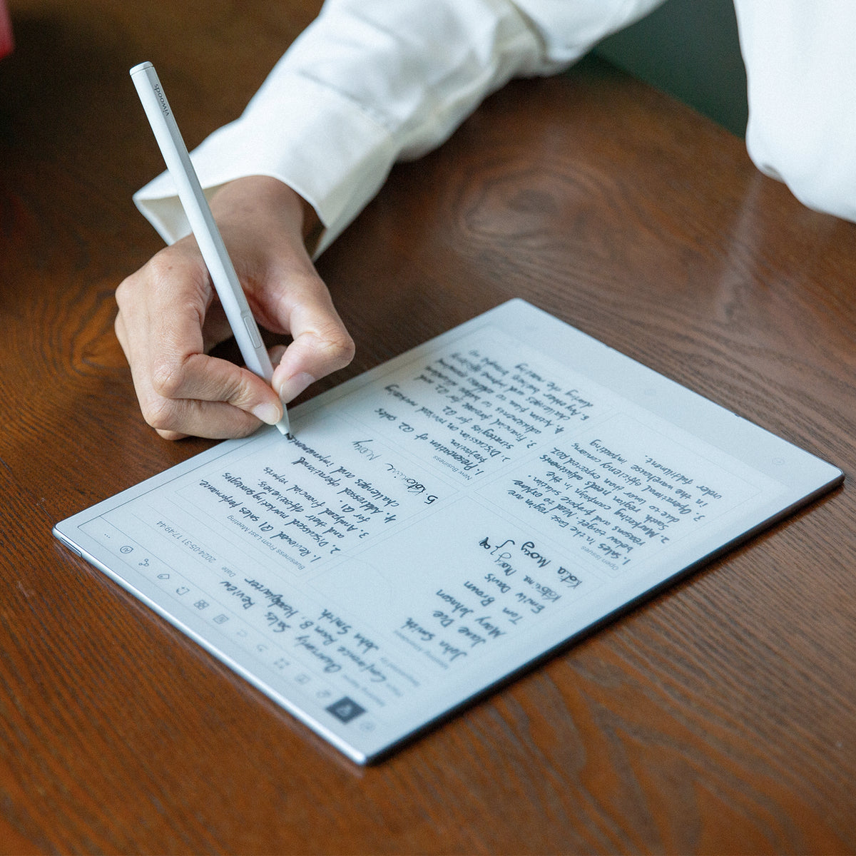 Person writing structured notes on Viwoods AiPaper with a stylus